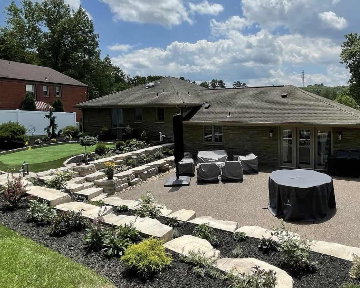 The backyard of a house with a putting green.