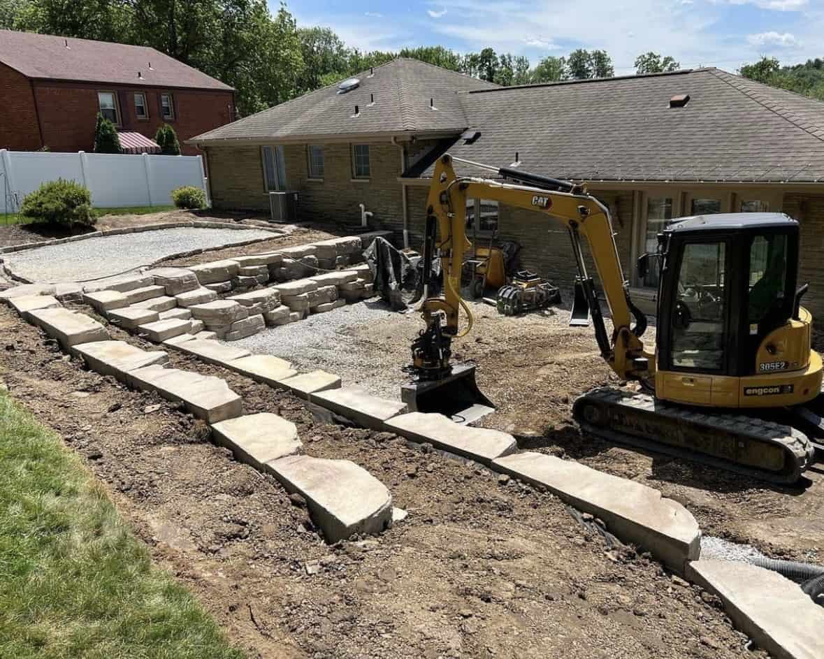 The backyard of a house being excavated.