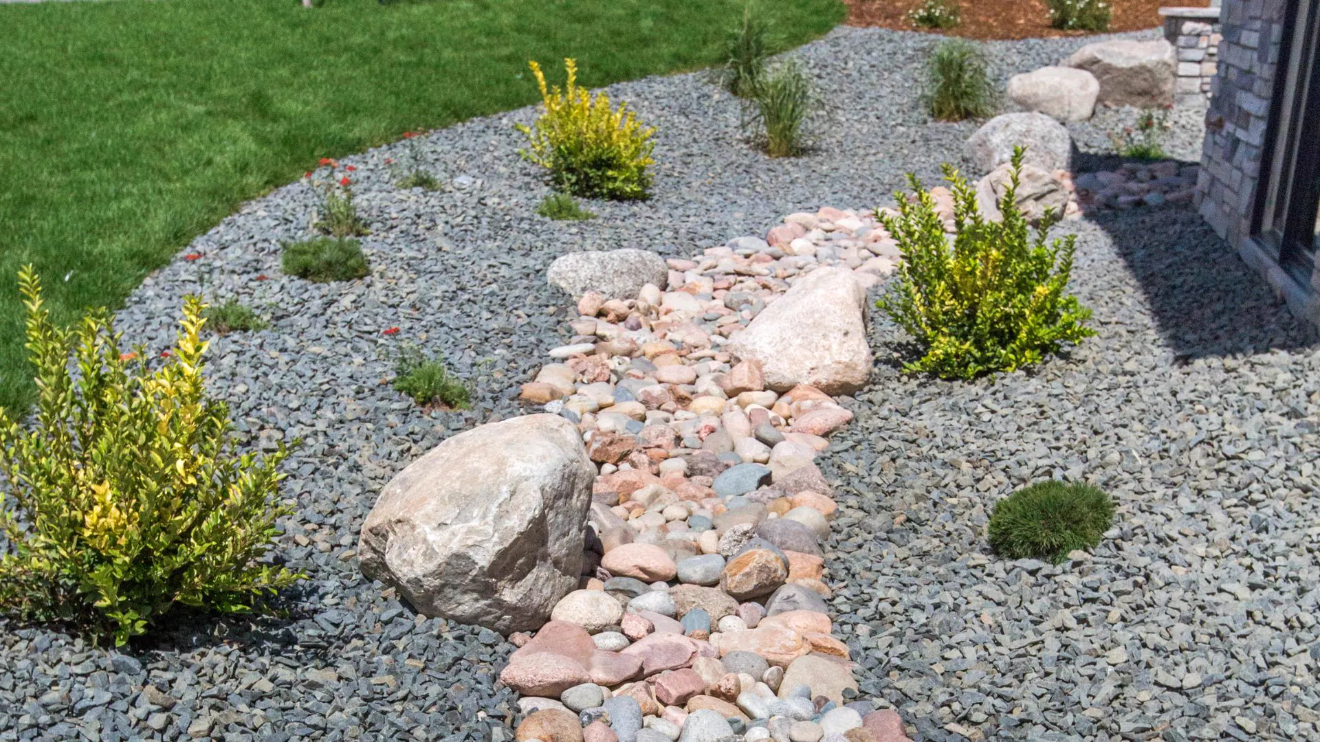 Decorative stone dry creek bed and garden installation in Pittsburgh