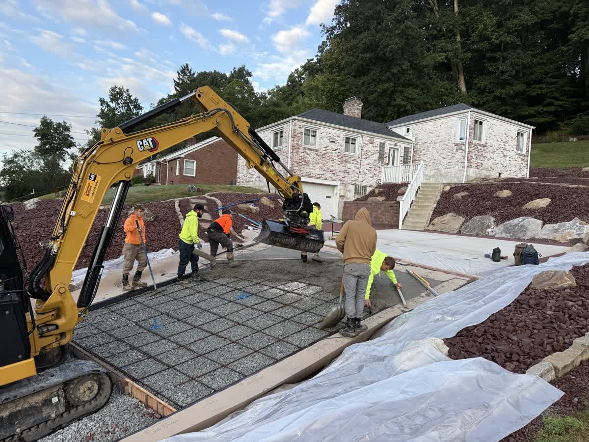 New concrete driveway with red exposed aggregate border in Pleasant Hills