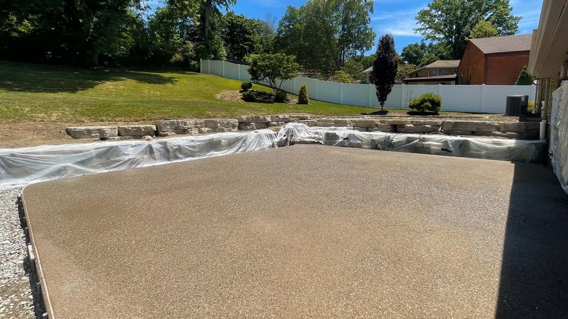 Exposed aggregate patio and outcropping wall in Bethel Park