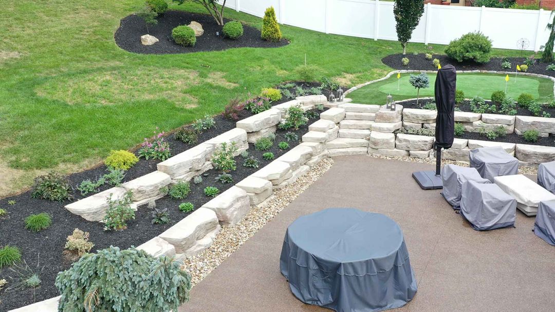 Outcropping wall and patio landscaping installation in Bethel Park