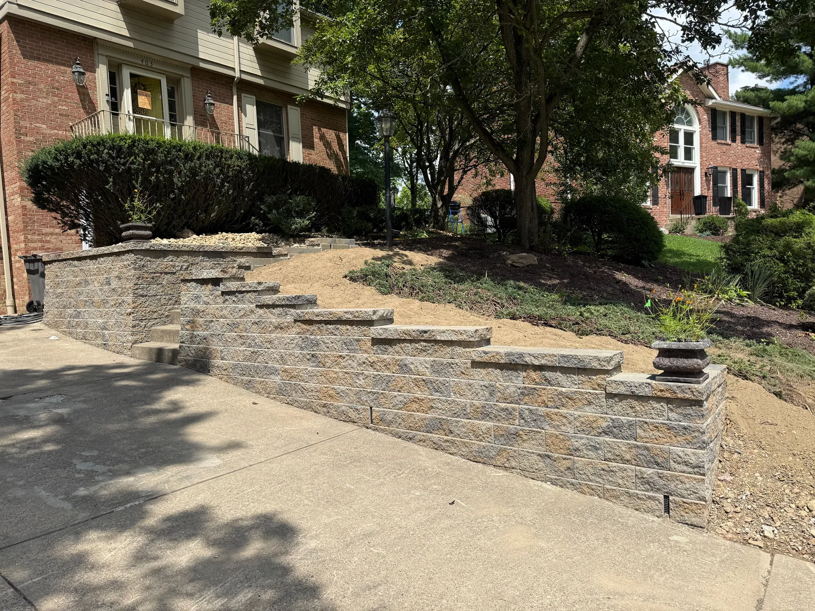 New Versa-Lok wall with a stepped cap beside the driveway
