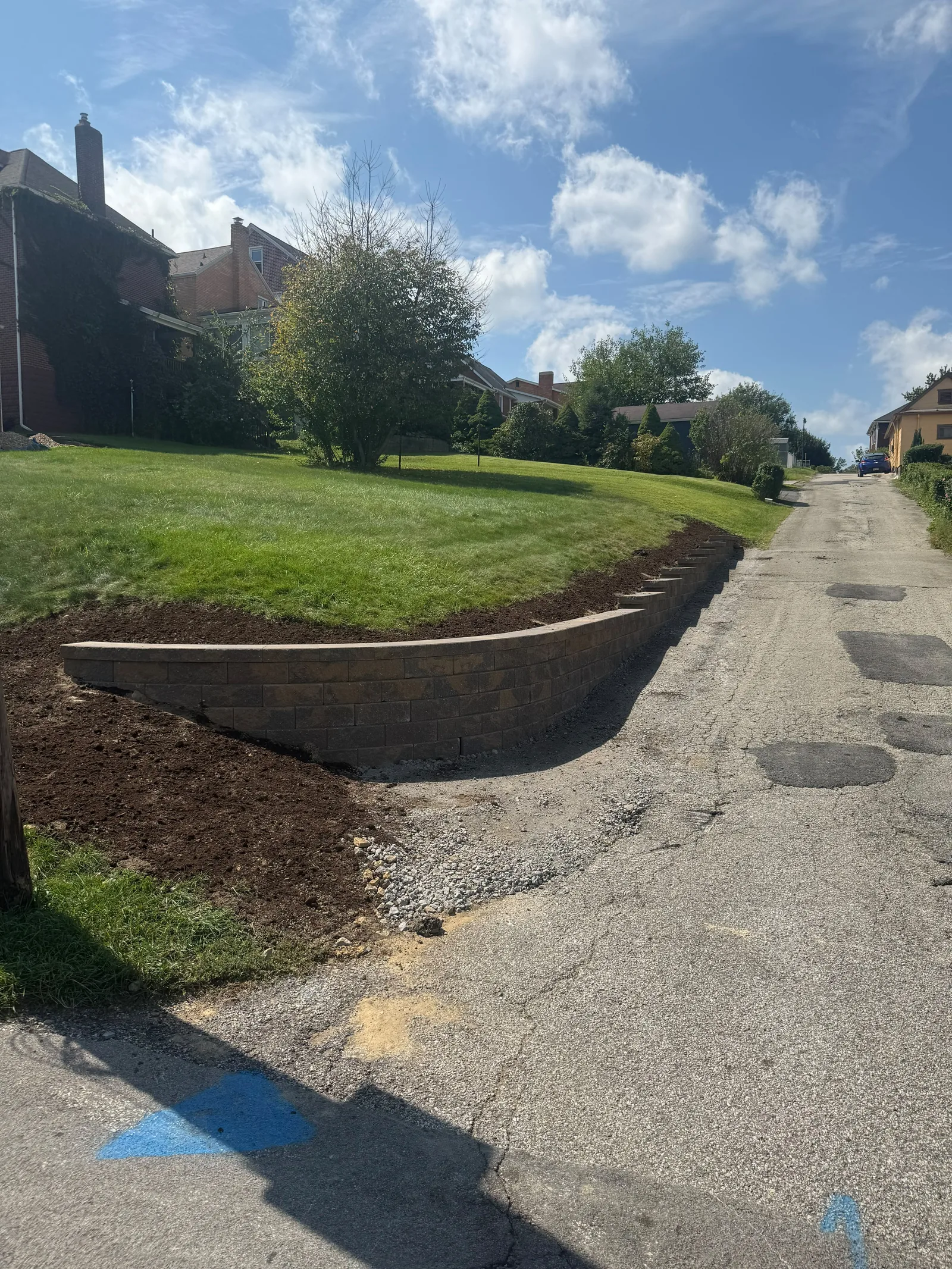 New Versa-Lok wall curving along the lawn above the street