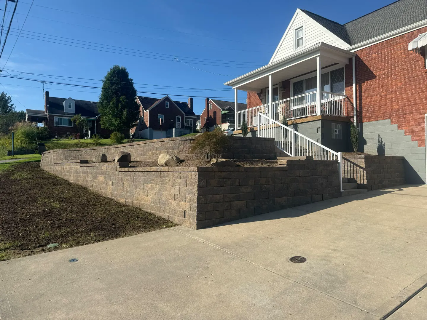 Terraced block retaining wall with boulder planting bed in the South Hills of Pittsburgh